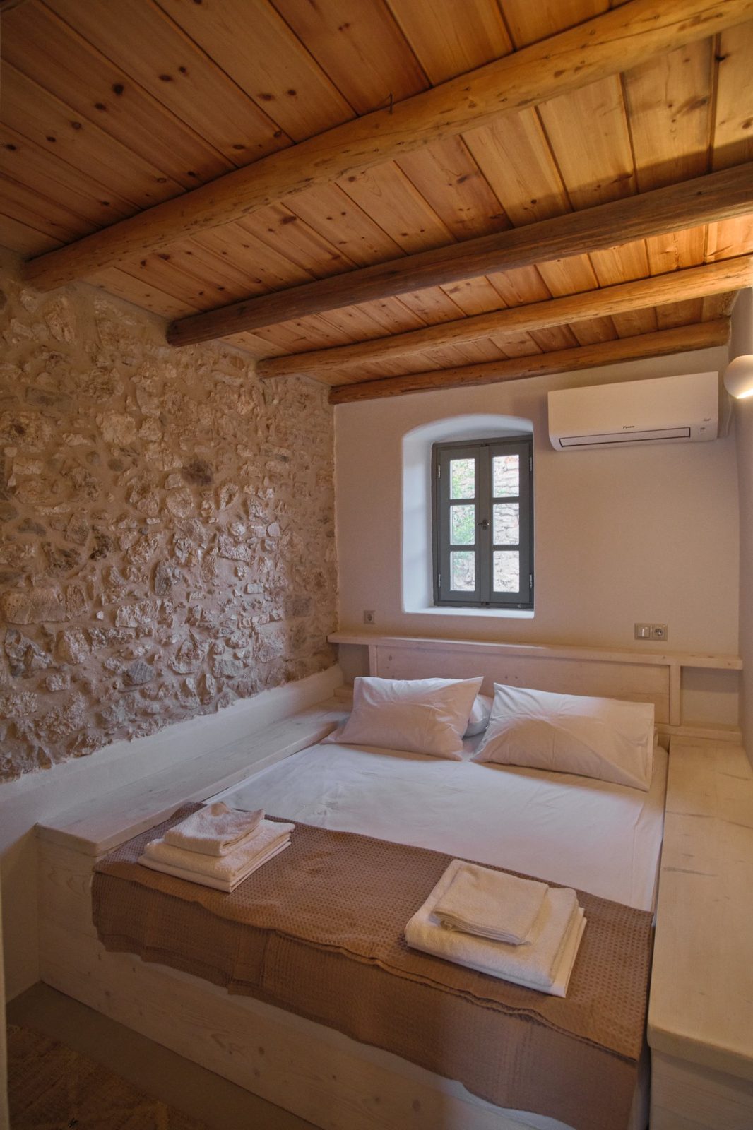 Bedroom with stone wall